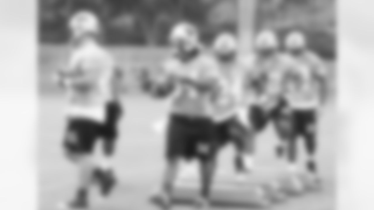 The running backs and fullbacks go through a drill.