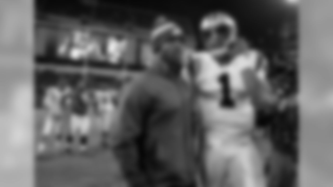 Injured Philadelphia Eagles quarterback Michael Vick stands on the field with Carolina Panthers quarterback Cam Newton (1) after an NFL football game Monday, Nov. 26, 2012, in Philadelphia. (AP Photo/Mel Evans)