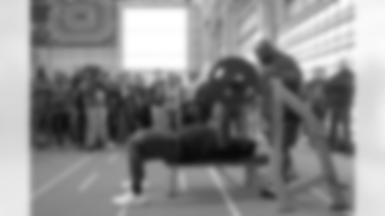 Ikem Ekwonu demonstrates his bench press skills for NFL scouts during North Carolina State Pro Day, Tuesday, March 29, 2022, in Raleigh, N.C. (AP Photo/Chris Seward)