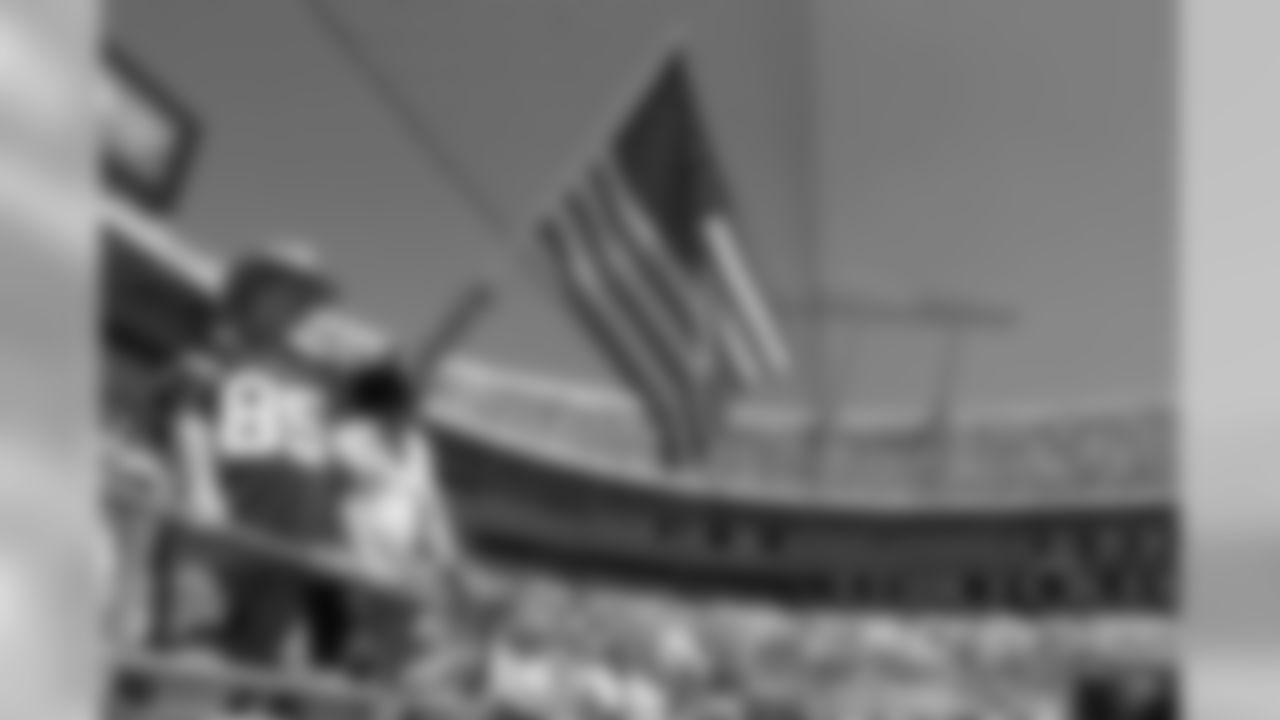 Don Fowlkes, left, of Danville, Va., waves a U.S. flag before the start of the Carolina Panthers game against the Baltimore Ravens in Charlotte, N.C., Sunday, Sept. 8, 2002. (AP Photo/Chuck Burton)