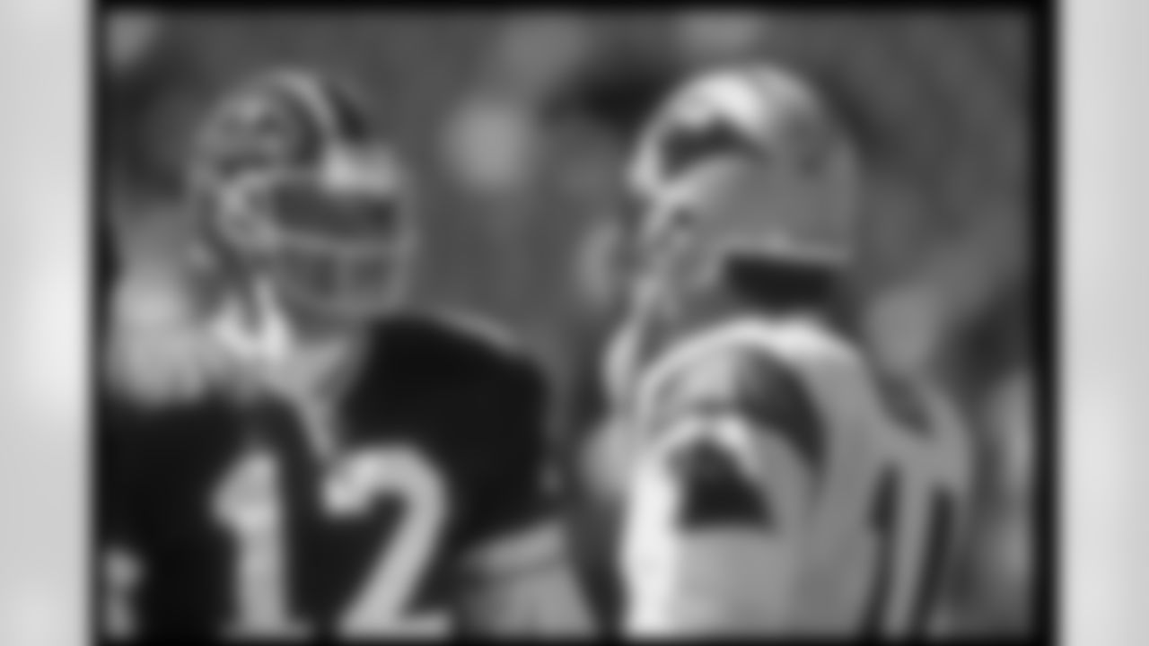 10 Sep 1995: Quarterback Jim Kelly of the Buffalo Bills (left) confers with Carolina Panthers quarterback Frank Reich during a game at Rich Stadium in Orchard Park, New York. The Bills won the game, 31-9.