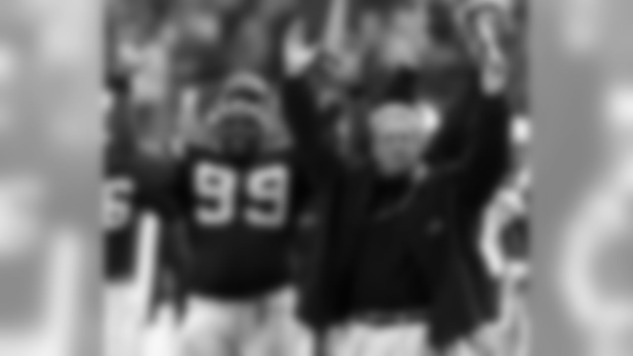 Carolina Panthers head coach John Fox, right, and Brentson Buckner (99) celebrate Steve Smith's 87-yard punt return for a touchdown in the third quarter of the Panthers' 52-31 win over the Cincinnati Bengals at Ericsson Stadium in Charlotte, N.C., Sunday Dec. 8, 2002. (AP Photo/Rusty Burroughs)