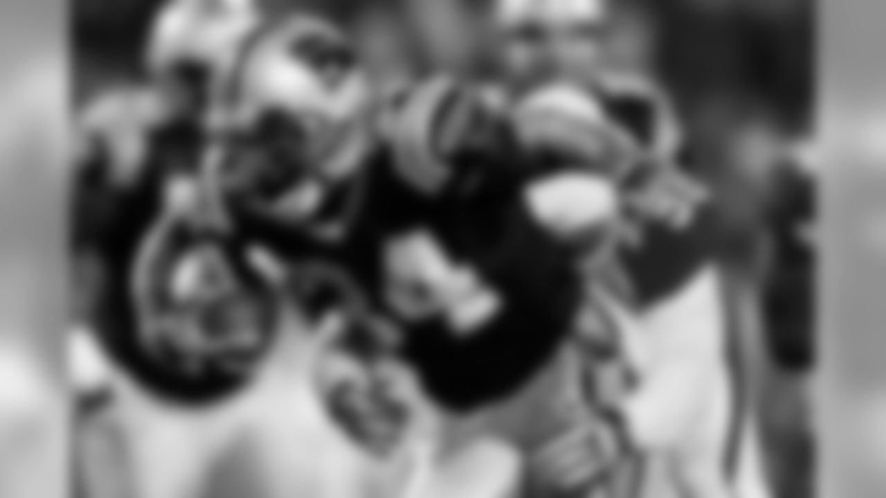 DeAngelo Williams bursts through Bert Berry for some of his team-leading 63 yards against Arizona.