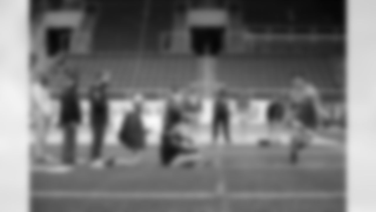 NFL scouts watch as North Dakota State lineman Dillon Radunz does drills at the school's football NFL Pro Day Friday, March, 12, 2021, in Fargo, North Dakota. (AP Photo/Andy Clayton- King)