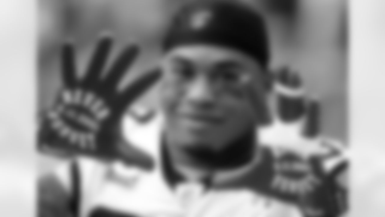 Carolina Panthers wide receiver Steve Smith displays his gloves prior to an NFL football game against the Arizona Cardinals, Sunday, Sept. 11, 2011, in Glendale, Ariz. Sunday was the 10th anniversary of the 9/11 attacks. (AP Photo/Ralph Freso)