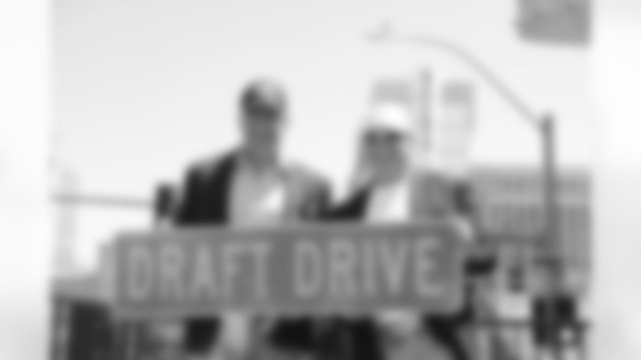 NFL Commissioner Roger Goodell (L) poses with Las Vegas Raiders owner Mark Davis and a Draft Drive ceremonial street sign on Thursday, April 28, 2022, in Las Vegas. The corner of Las Vegas Blvd. and Flamingo was temporarily renamed for the NFL Draft being held April 28-30. (AP Photo/Gregory Payan)