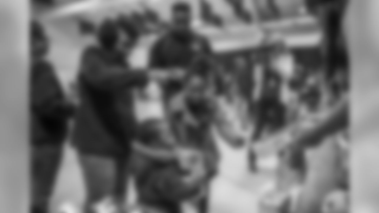 Thomas Davis and Mike Adams hand out toys to children on Tuesday, December 18, 2018.