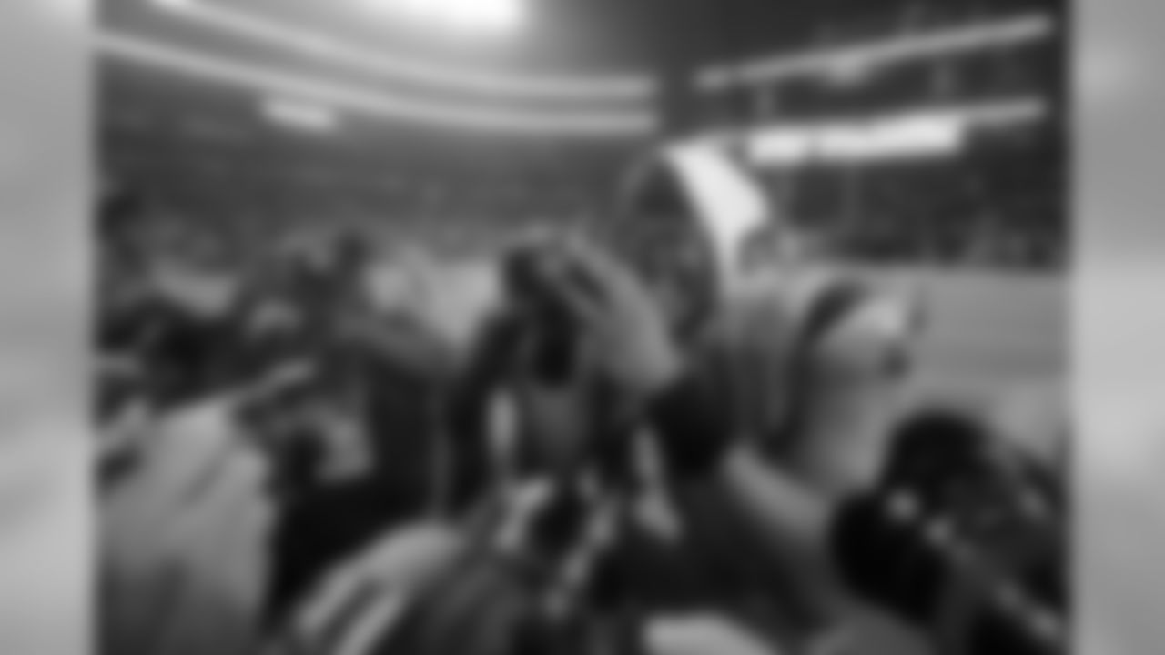 Carolina Panthers quarterback Cam Newton (1) takes photos of photographers taking his picture as he celebrates the team's 33-14 win over the Dallas Cowboys in an NFL football game, Thursday, Nov. 26, 2015, in Arlington, Texas. (AP Photo/Michael Ainsworth)