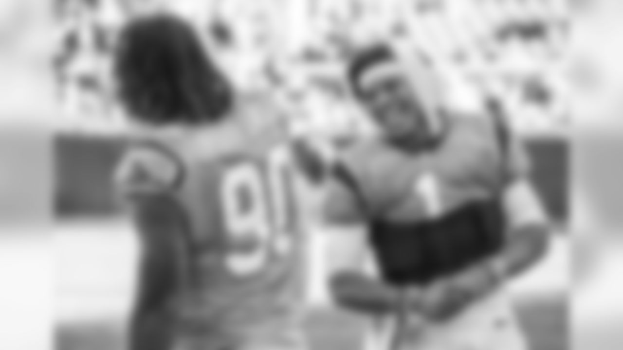Cam Newton and Julius Peppers laugh on the sidelines during a week 8 game against the Baltimore Ravens at Bank of America Stadium on Sunday, October 28, 2018.
