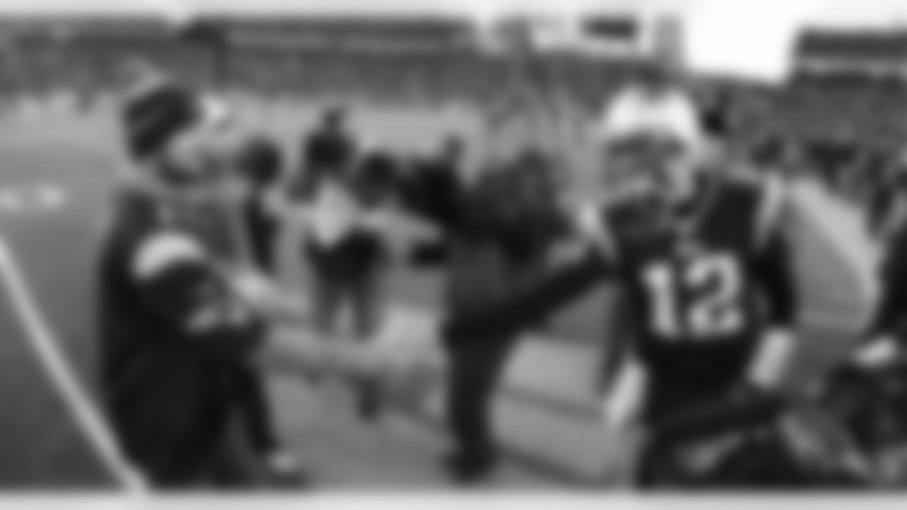Tom Brady shakes hands with Jon Lester of the Red Sox