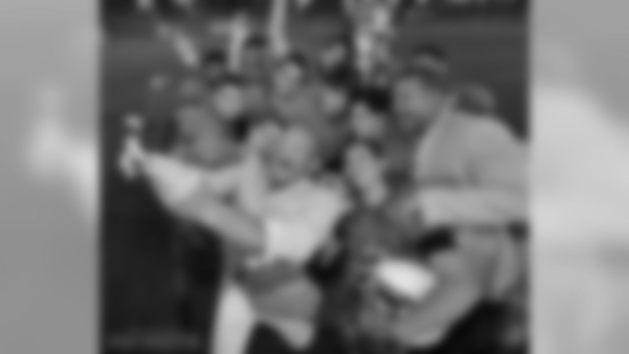 Aeneas Williams and Andre Reed (far right) take a selfie with players of an Israeli Football League team.