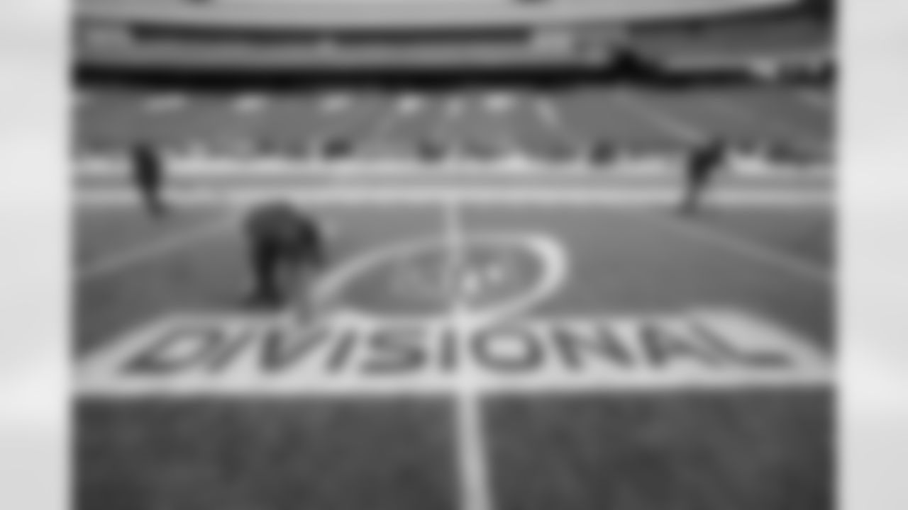 Gillette Stadium field crew foreman Joshua Bergeron, of Providence, R.I., applies paint to an NFL football AFC championship divisional round logo, Monday, Jan. 8, 2018, at Gillette Stadium in Foxborough, Mass. The Patriots are scheduled to host the Tennessee Titans in the AFC divisional round game, Saturday, Jan. 13, 2018, in Foxborough. (AP Photo/Steven Senne)