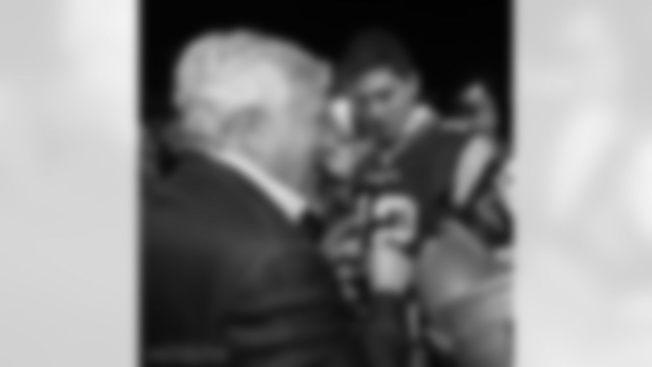 Robert Kraft autographs a Tom Brady jersey.