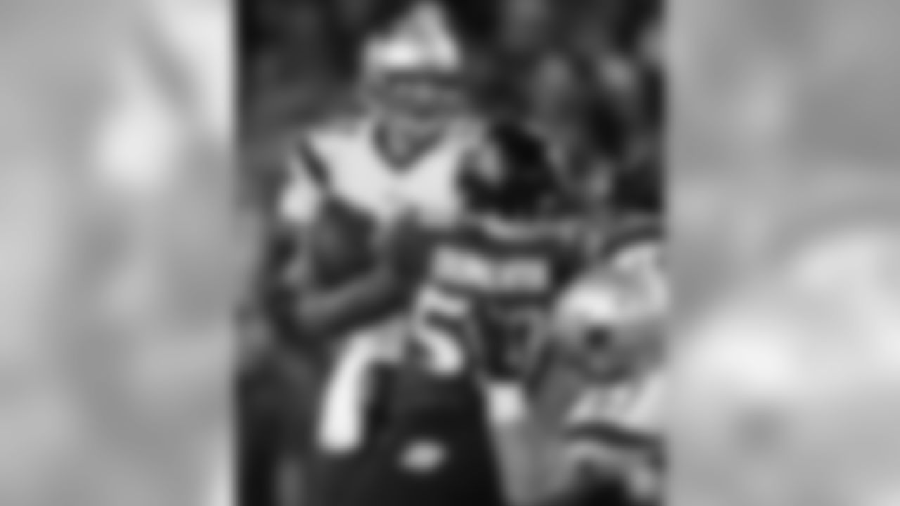 Tom Brady is pressured by Ravens DE Elvis Dummervil