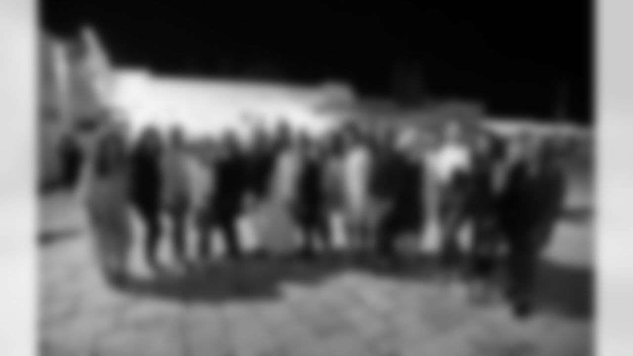 The wives, girlfriends and guests of the NFL Hall of Famers pose for a photo near the Western Wall.