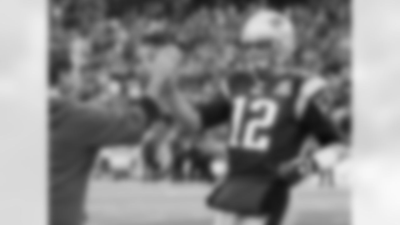 New England Patriots quarterback Tom Brady (12) high-fives head coach Bill Belichick near the end of their 35-7 victory over the Jacksonville Jaguars in an NFL football game in Foxborough, Mass. Sunday, Dec. 27, 2009. With the victory, the Patriots clinched a playoff spot while winning the AFC East Division.(AP Photo/Elise Amendola)