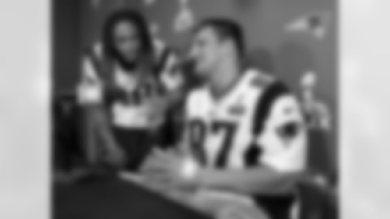 New England Patriots tight end Rob Gronkowski (87) is questioned about his favorite music by running back Brandon Bolden (38) during a news conference Thursday, Jan. 29, 2015, in Chandler, Ariz.