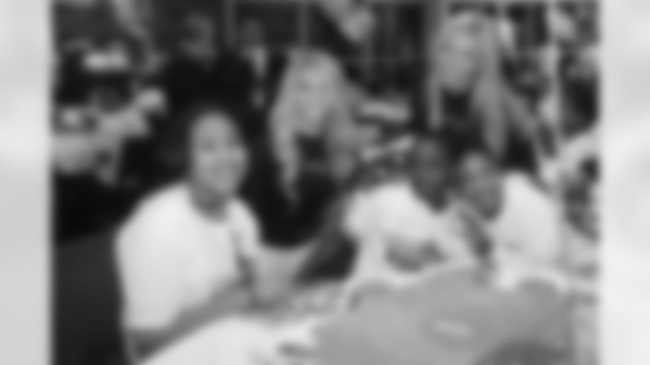 Camille and Erica pose with kids at the Children's Holiday Party