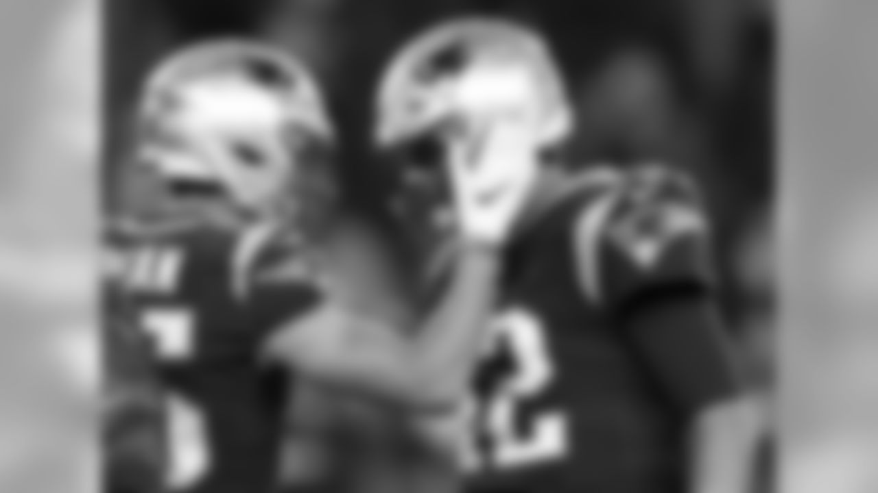 New England Patriots wide receiver Chris Hogan, left, and quarterback Tom Brady speak as they warm up before an NFL football game against the Kansas City Chiefs, Sunday, Oct. 14, 2018, in Foxborough, Mass. (AP Photo/Michael Dwyer)
