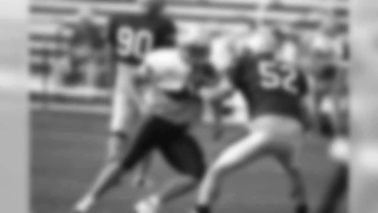 Monty Beisel(52) matches up with running back Heath Evans(44) during a blocking drill on day 4 of Training Camp. 7/31/2006 Photo by David Silverman