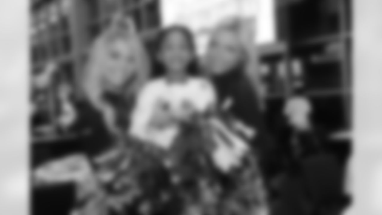 Erica and Camille pose with a young girl
