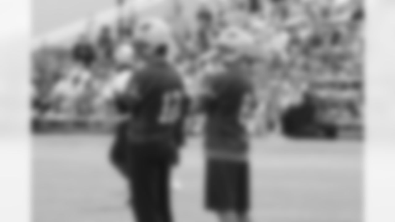 Tom Brady and Brian Hoyer look on during training camp drills