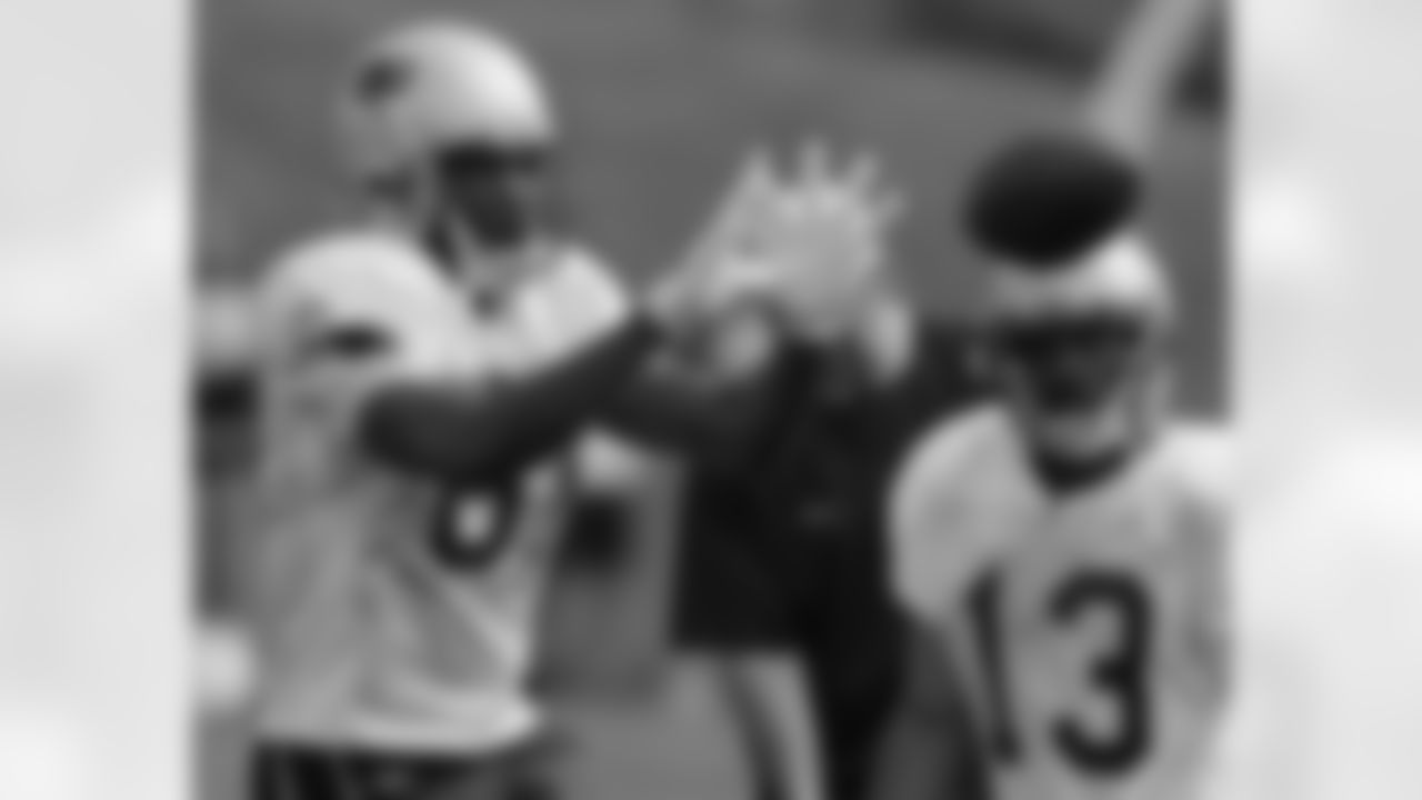 New England Patriots wide receiver Randy Moss hauls in a pass as wide receiver Bam Childress looks on during the first session of the NFL football team's first day of training camp in Foxborough, Mass., Friday morning, July 27, 2007. Photo by Stephan Savoia