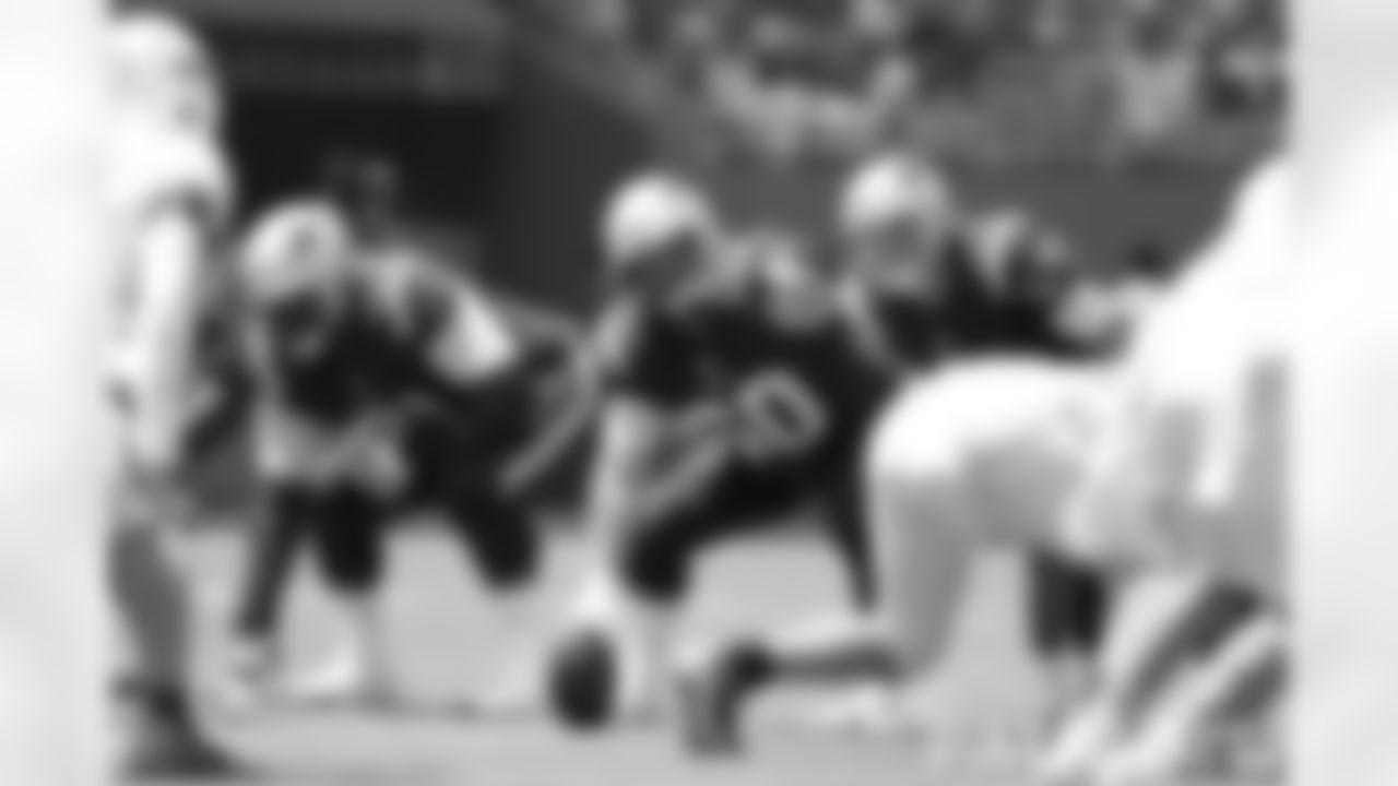 David Andrews (60) and Mac Jones (10) makes pre snap identification against the Miami Dolphins