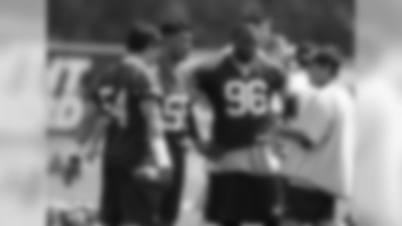 Patriots head coach Bill Belichick gives instructions to linebackers Tedy Bruschi(54), Junior Seau(55) and Adalius Thomas(96) on day three of mini camp at Gillette Stadium. 6/7/2007 Photo by David Silverman