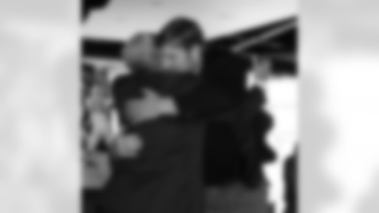 Patriots owner Robert Kraft hugs Matt Light after his ceremony.