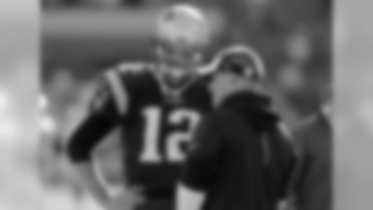 New England Patriots quarterback Tom Brady and offensive coordinator Josh McDaniels confer before an NFL football game between the Patriots and the Washington Redskins, Sunday, Nov. 8, 2015, in Foxborough, Mass. (AP Photo/Charles Krupa)