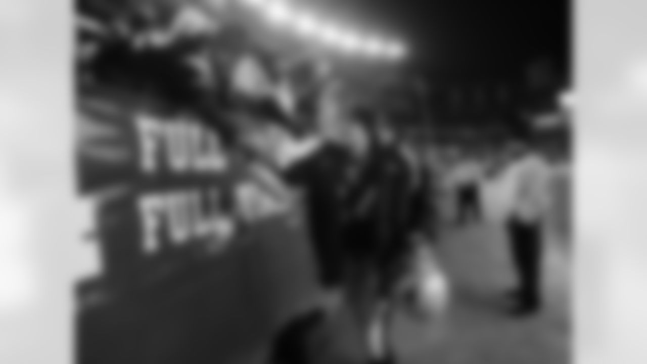 New England Patriots' Tedy Bruschi slaps hands with fans after the Patriots defeated the Jacksonville Jaguars, 28-3, in their wild card playoff football game in Foxborough,. Mass. ,Saturday, Jan. 7, 2006. (AP Photo/Winslow Townson)