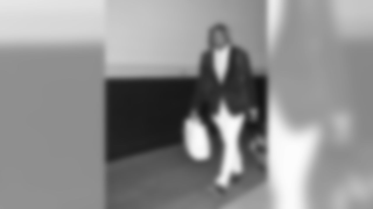 Is that a velvet jacket? And how about the soles of the shoes matching the shoelaces! That's some attention to detail. Points off for the headphones but Tavon Wilson makes up for it with the carry-on by luxury brand MCM.