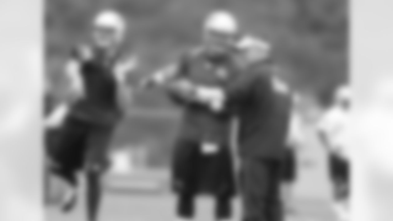 Tim Tebow talks with Josh McDaniels