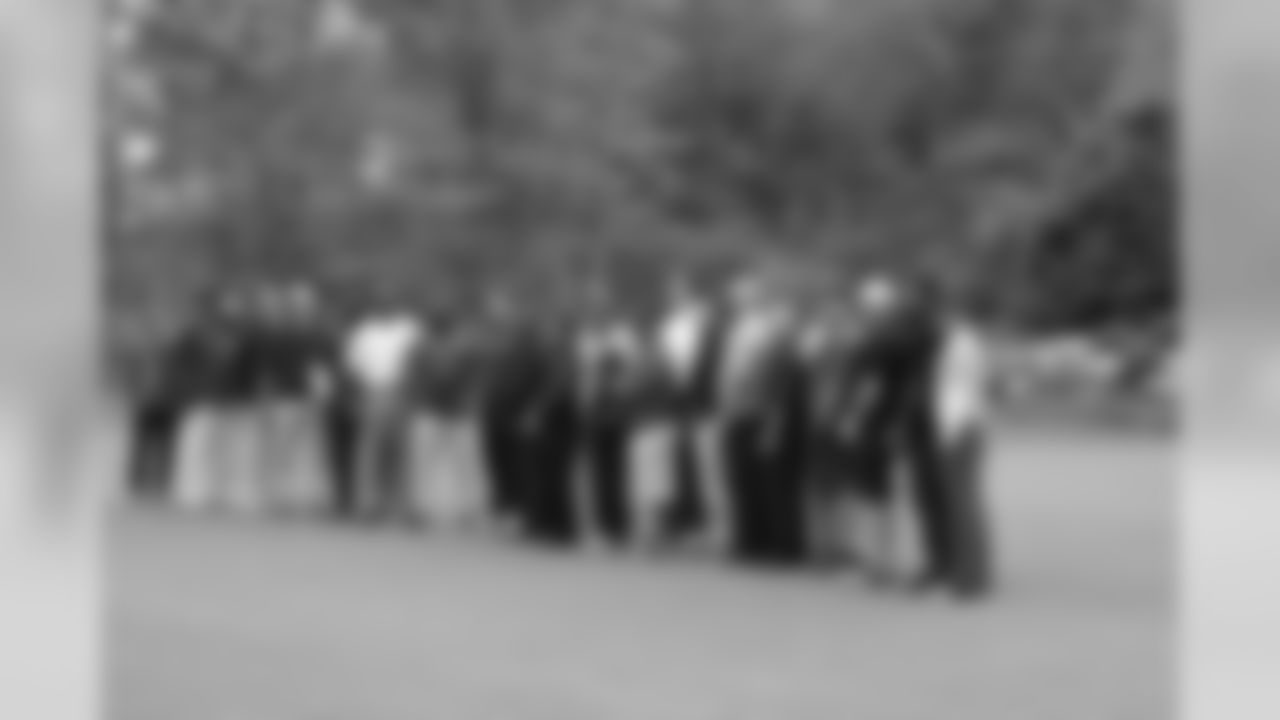 Current and former members of the Patriots pose for a group photo