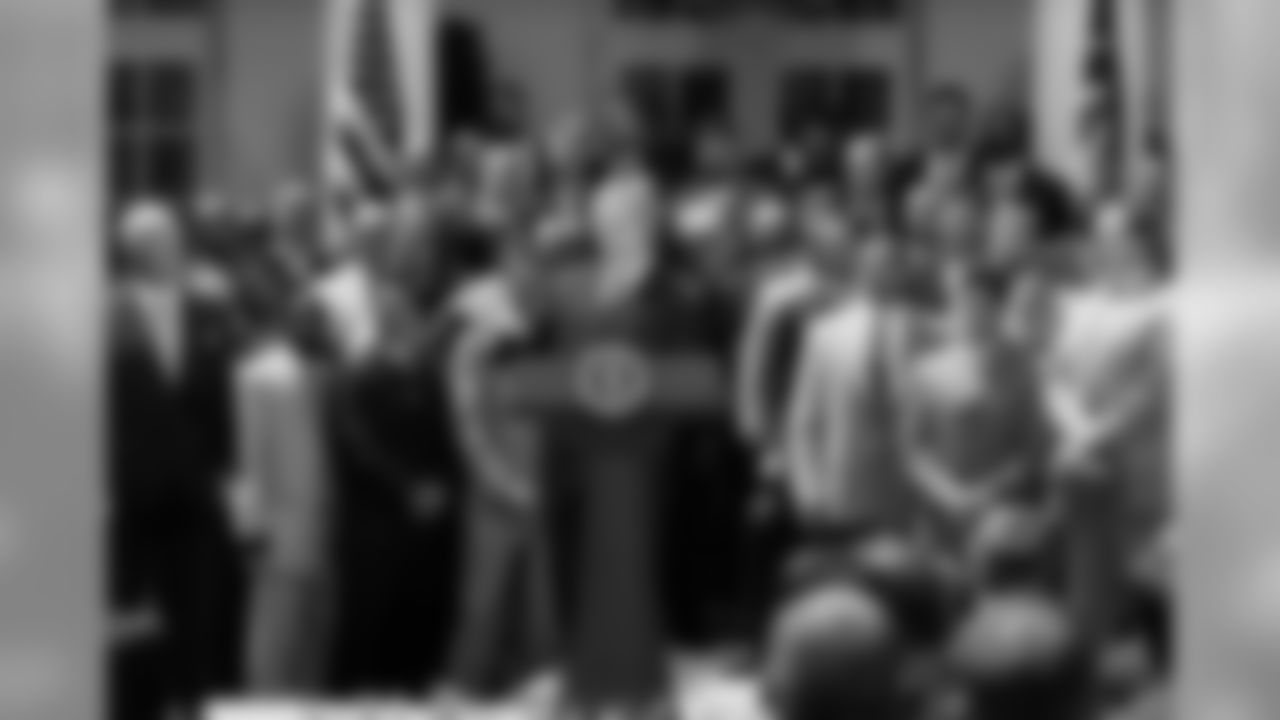 President Bush, center, speaks after meeting with the 2004 National Football League champion New England Patriots, Monday, May 10, 2004, in the Rose Garden of the White House. (AP Photo/Ron Edmonds)