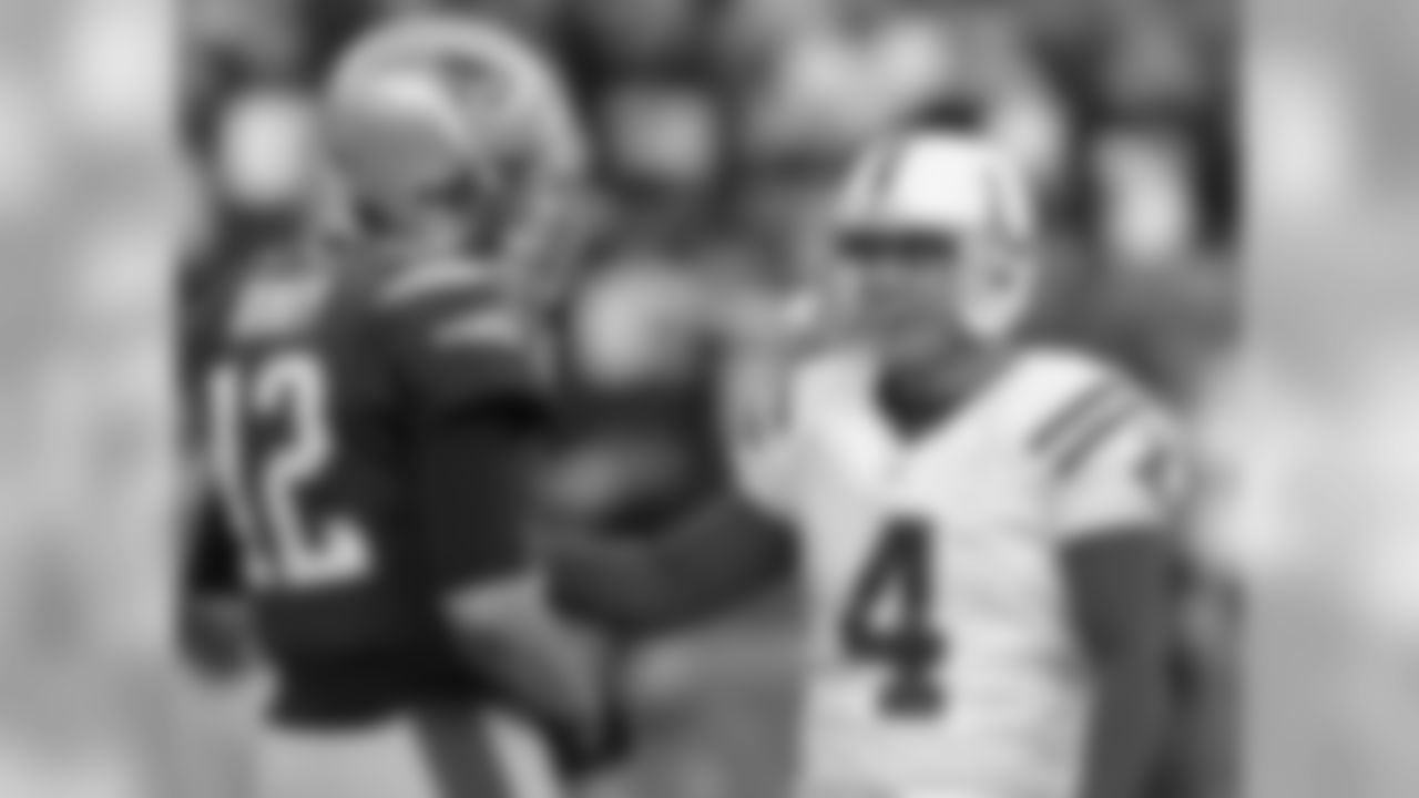 Former teammates, New England Patriots quarterback Tom Brady (12) and Indianapolis Colts kicker Adam Vinatieri (4) talk prior to an NFL football game at Gillette Stadium in Foxborough, Mass., Sunday, Nov. 18, 2012. (AP Photo/Steven Senne)