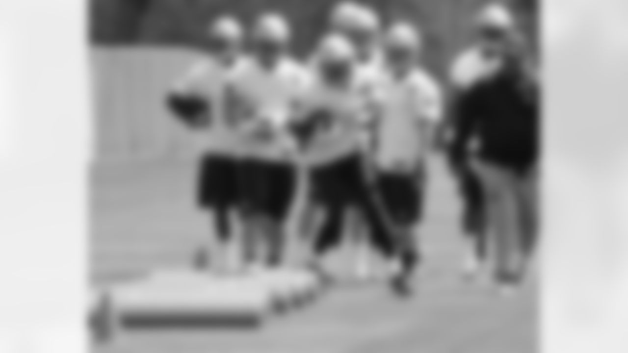 Receivers and Running backs run through a drill