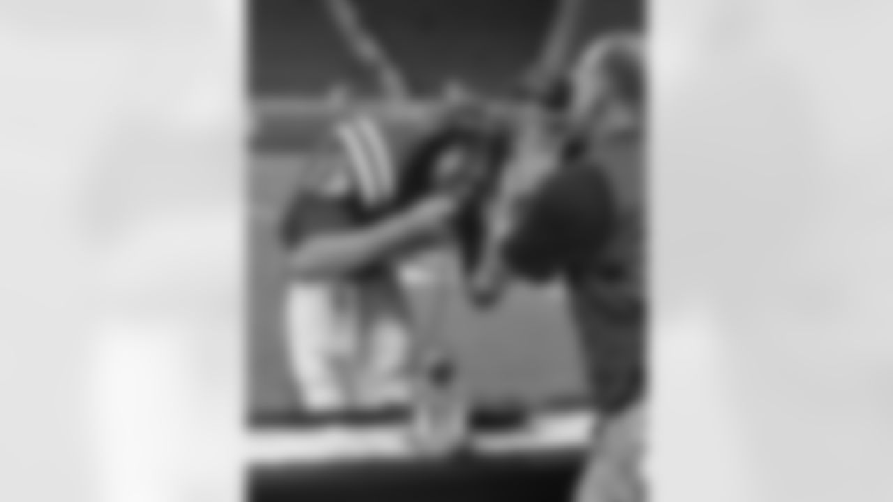 Quarterback Tom Brady (12) of the New England Patriots spoons a sample from the skillet after winning the Phil Simms iron award for play against the Detroit Lions November 25, 2010 at Ford Field in Detroit, Michigan.  (AP Photo / Al Messerschmidt)