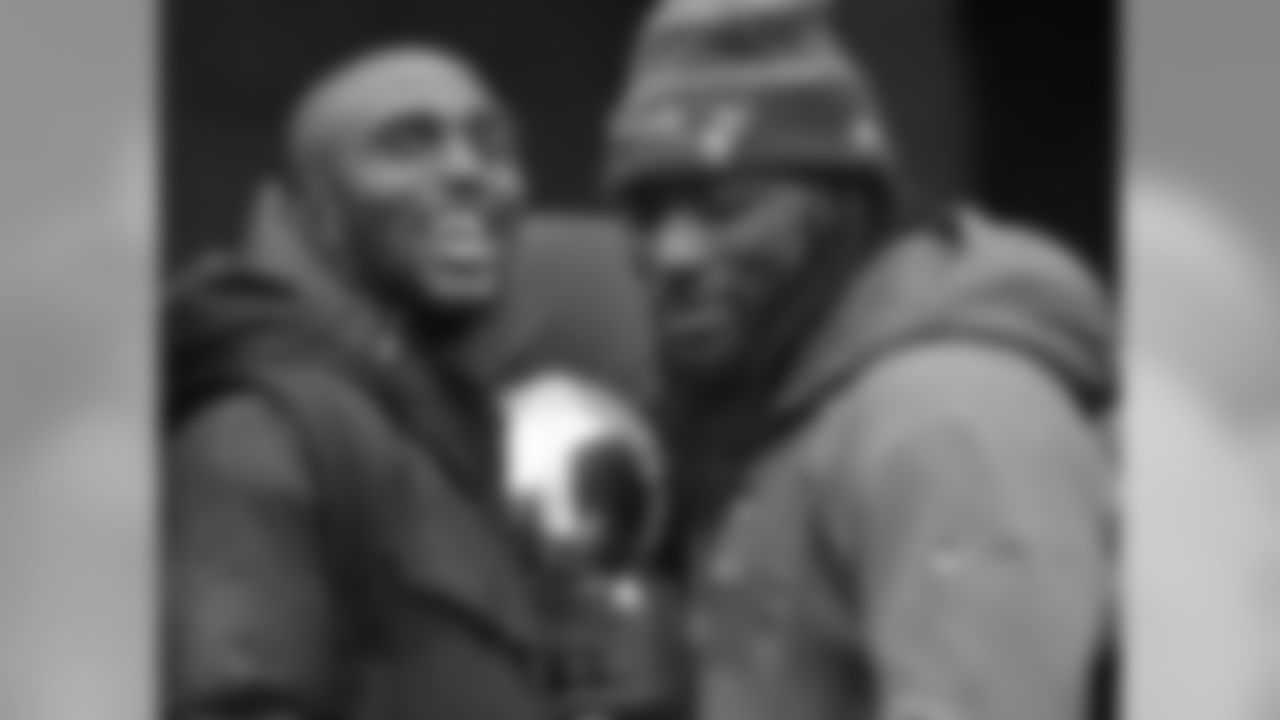 New England Patriots safety Devin McCourty, left, and running back LeGarrette Blount hold a Super Bowl trophy during a rally Tuesday, Feb. 7, 2017, in Boston, to celebrate Sunday's 34-28 win over the Atlanta Falcons in the NFL Super Bowl 51 football game in Houston. (AP Photo/Elise Amendola)