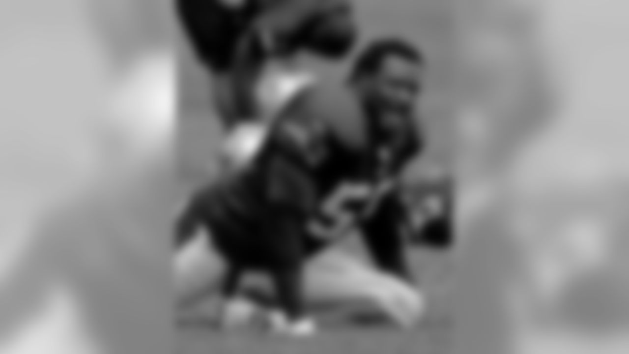 New England Patriots linebacker Willie McGinest (55) jokes with a teammate during stretching exercises at the start of practice during Patriots pre-season camp in Foxborough, Mass., Tuesday afternoon Aug. 23, 2005. (AP Photo/Stephan Savoia)