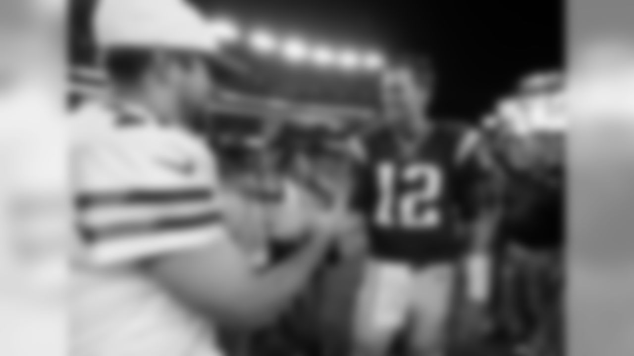 Green Bay Packers quarterback Aaron Rodgers, left, and New England Patriots quarterback Tom Brady, right, meet on the field after an NFL preseason football game Thursday, Aug. 13, 2015, in Foxborough, Mass. The Packers won 22-11. (AP Photo/Michael Dwyer)