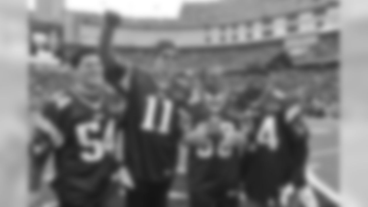 Patriots honorary captains Teddy Bruschi (54), Drew Bledsoe (11), Troy Brown (80) and Ty Law (24) wave to the Gillette Stadium crowd