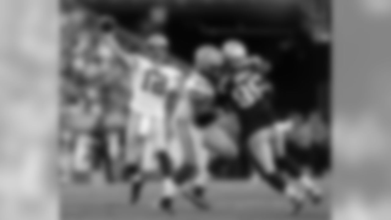Green Bay Packers quarterback Aaron Rodgers (12) passes as tackle David Bakhtiari (69) blocks New England Patriots defensive end Chandler Jones (95) during the first half of an NFL preseason football game Thursday, Aug. 13, 2015, in Foxborough, Mass. (AP Photo/Michael Dwyer)