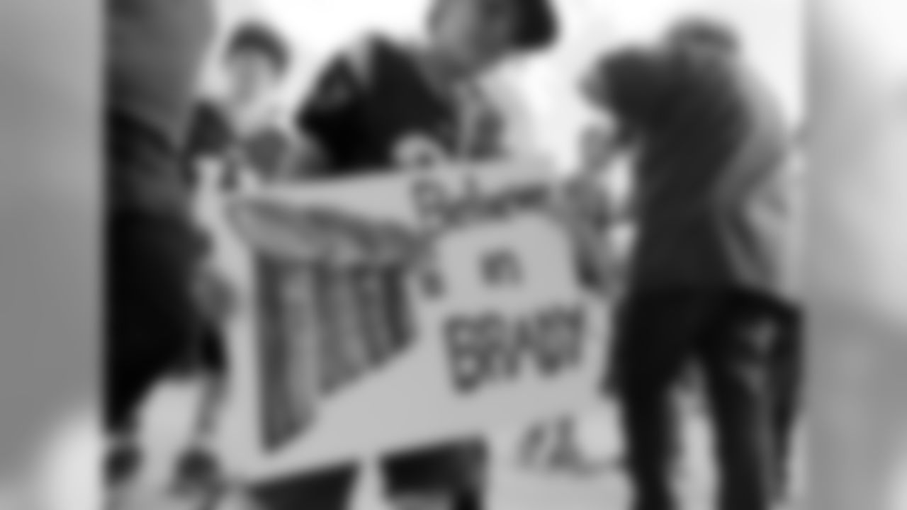 A New England Patriots fan carries a sign supporting Patriots quarterback Tom Brady as he arrives an NFL preseason football game between the Patriots and the Green Bay Packers Thursday, Aug. 13, 2015, in Foxborough, Mass. (AP Photo/Charles Krupa)