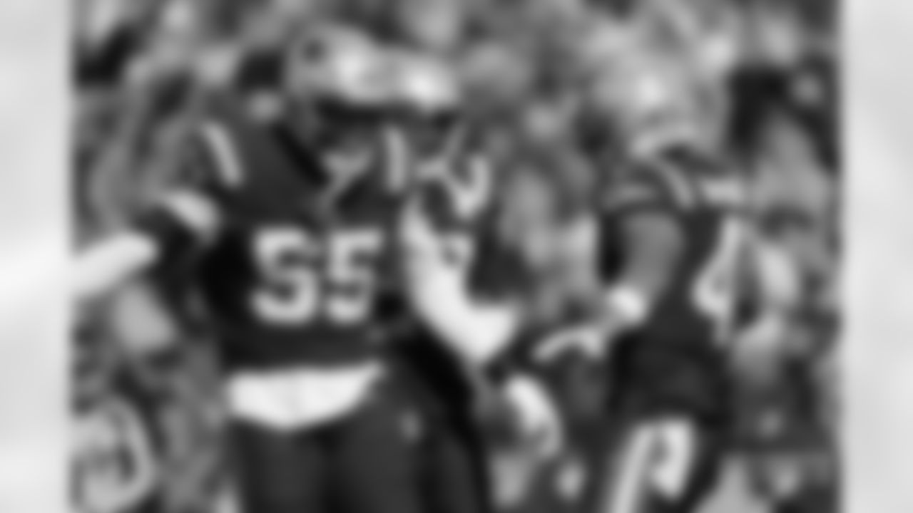 Josh Uche (55) celebrates a play with Myles Bryant (41)