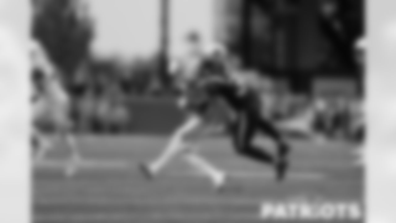 Mac Wilson jumping on a Colt's player to make the tackle