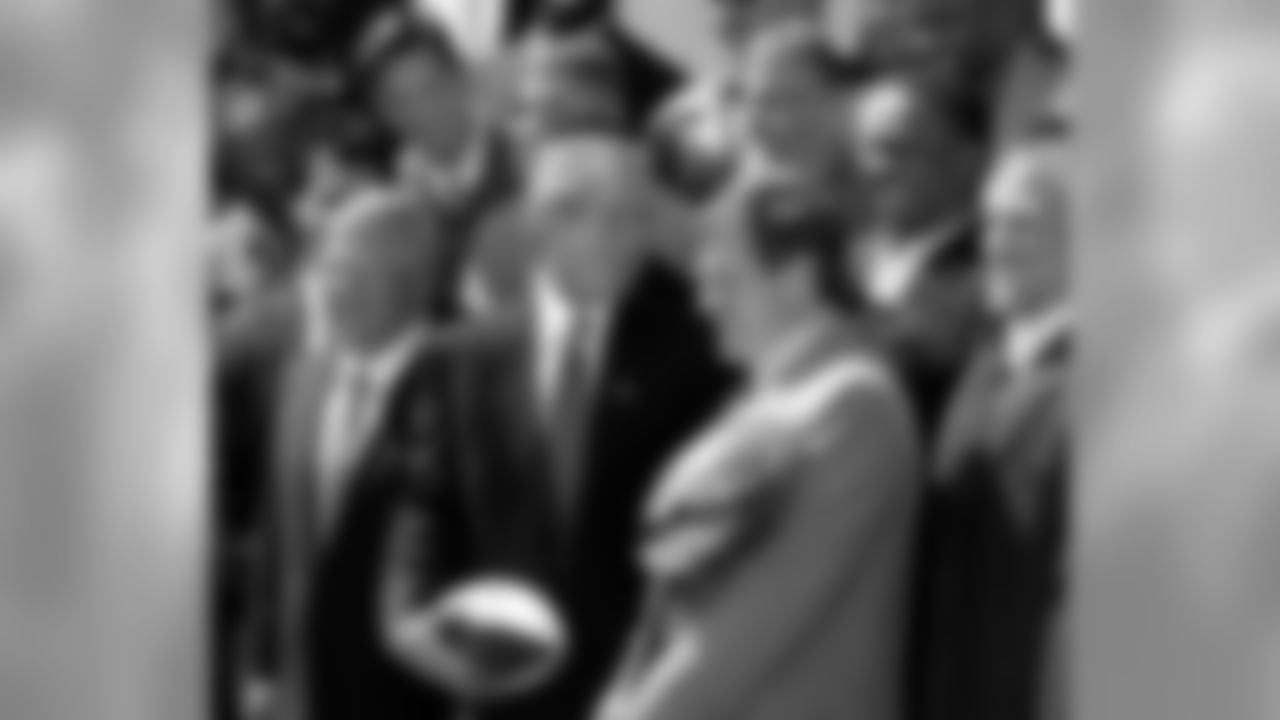President Bush stands next to Robert Kraft, left foreground, owner of the Super Bowl champion New England Patriots and Patriots head coach Bill Belichick, holding the Super Bowl Trophy, as the Super Bowl champions are honored in the Rose Garden at the White House in Washington Tuesday, April 2, 2002. (AP Photo/Doug Mills)