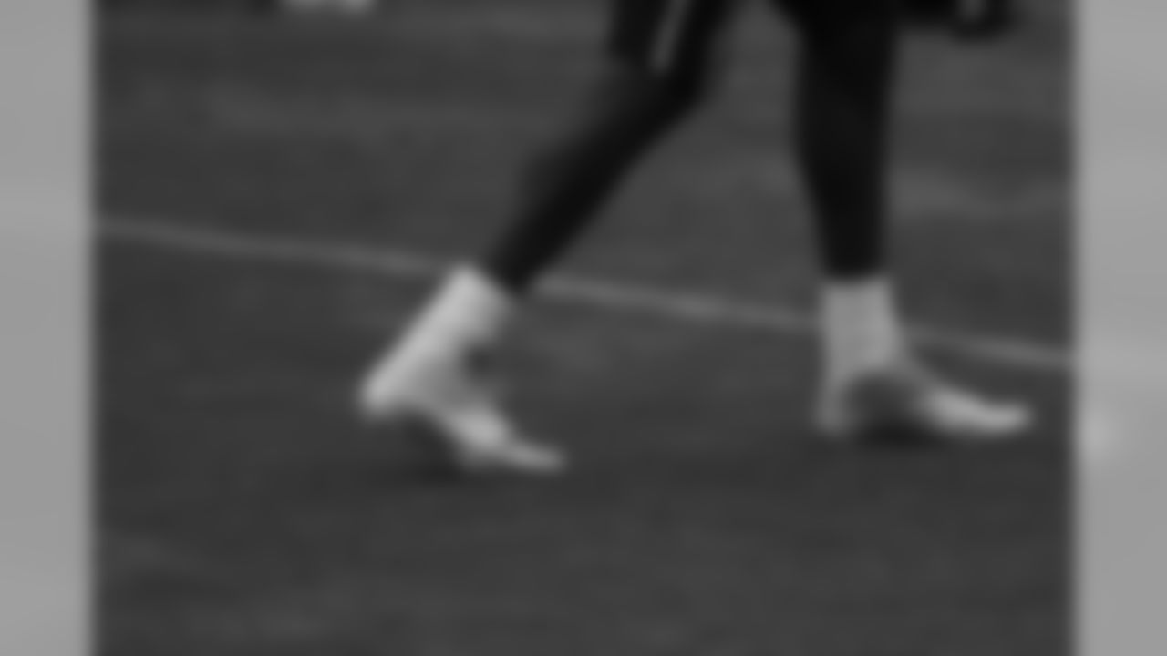 Chad Ochocinco displays his new gold cleats at practice