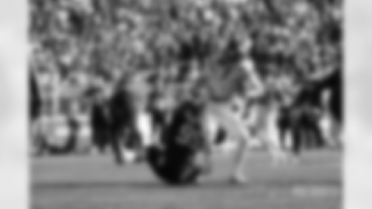 Mike White (5) is sacked by DT Daniel Ekuale (95)